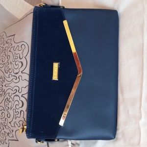 Joy Iman Blueish Purple Leather Clutch.